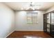 A bedroom has hardwood floors, a ceiling fan, and a large window at 2762 E Clifton Ave, Gilbert, AZ 85295