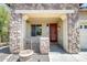 Inviting front porch with stone accents, decorative metal gate, and a warm, wood front door at 2762 E Clifton Ave, Gilbert, AZ 85295
