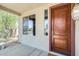 A welcoming front porch with a wood door and a large side window for plenty of natural light at 2762 E Clifton Ave, Gilbert, AZ 85295