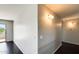 Hallway with neutral walls, sleek flooring, and views to the outdoors via a sliding glass door at 2762 E Clifton Ave, Gilbert, AZ 85295