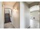 Hallway with staircase, decorative lighting, and tiled flooring leading to the living areas at 2762 E Clifton Ave, Gilbert, AZ 85295