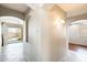 An hallway with tile floors, archways, and views to a kitchen and a door to the backyard patio at 2762 E Clifton Ave, Gilbert, AZ 85295