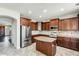 A well-equipped kitchen features custom cabinets, granite counters, stainless steel appliances, and a center island at 2762 E Clifton Ave, Gilbert, AZ 85295