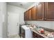 Efficient laundry room features overhead cabinets, countertop space, and modern washer/dryer at 2762 E Clifton Ave, Gilbert, AZ 85295