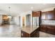 The Kitchen and Living Room are adjacent and feature tile flooring and a stone fireplace at 2762 E Clifton Ave, Gilbert, AZ 85295