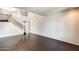 A spacious living room featuring dark wood floors, neutral walls, and a staircase with wood and metal accents at 2762 E Clifton Ave, Gilbert, AZ 85295