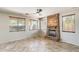The living room has tile floors, a ceiling fan, and a stone fireplace with many windows and natural light at 2762 E Clifton Ave, Gilbert, AZ 85295