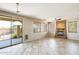 Bright living room with tile flooring, a stone fireplace, and a sliding glass door to the patio at 2762 E Clifton Ave, Gilbert, AZ 85295