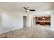 An open concept living room flows seamlessly with tile flooring and access to the kitchen at 2762 E Clifton Ave, Gilbert, AZ 85295
