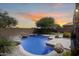 Backyard pool area with rock features, lush landscape, and clear water, creating a tranquil outdoor retreat at 2762 E Clifton Ave, Gilbert, AZ 85295