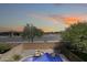 Backyard oasis with a sparkling pool, rock feature, and lush greenery, perfect for outdoor enjoyment at 2762 E Clifton Ave, Gilbert, AZ 85295