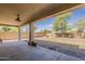 Covered back patio overlooking a large, private yard with rocks and a fire pit at 28054 N Jade St, San Tan Valley, AZ 85143