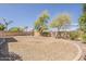 Large backyard featuring a block wall for privacy and desert landscaping, providing a serene outdoor space at 28054 N Jade St, San Tan Valley, AZ 85143