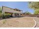 Large backyard featuring desert landscaping, covered patio, and ample space for outdoor activities at 28054 N Jade St, San Tan Valley, AZ 85143