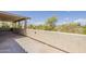 Open-air balcony with stucco railing overlooking lush greenery and neighborhood views at 28054 N Jade St, San Tan Valley, AZ 85143