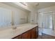 Bright bathroom featuring a shower, sliding glass door, and wide mirror at 28054 N Jade St, San Tan Valley, AZ 85143