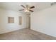Neutral bedroom with a ceiling fan, carpeted floor, and a bright window at 28054 N Jade St, San Tan Valley, AZ 85143