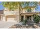 Charming two-story home with a three-car garage, covered entry and well-maintained front yard landscaping at 28054 N Jade St, San Tan Valley, AZ 85143