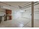 Clean garage with overhead lighting, workbench, cabinets, and epoxy floors at 28054 N Jade St, San Tan Valley, AZ 85143
