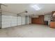 Spacious two-car garage with ample storage cabinets along the back wall at 28054 N Jade St, San Tan Valley, AZ 85143