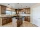 Updated kitchen with dark cabinets, granite countertops, tile backsplash, and stainless steel appliances at 28054 N Jade St, San Tan Valley, AZ 85143