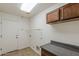 Functional laundry room with countertop, upper cabinet and access to the outside at 28054 N Jade St, San Tan Valley, AZ 85143