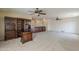 Spacious living room featuring built-in desk/shelving and neutral carpeting and paint at 28054 N Jade St, San Tan Valley, AZ 85143