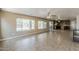 Large living room featuring an open layout, windows, and easy access to the kitchen and backyard at 28054 N Jade St, San Tan Valley, AZ 85143