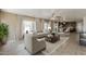 Staged living room featuring an open layout, neutral tones, stylish furnishings, and kitchen access at 28054 N Jade St, San Tan Valley, AZ 85143