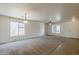 Spacious living room with carpet flooring, ceiling fan, and ample natural light, perfect for relaxation at 28054 N Jade St, San Tan Valley, AZ 85143