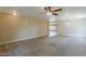 Large living room features a neutral color palette, carpet flooring and ceiling fan for added comfort at 28054 N Jade St, San Tan Valley, AZ 85143