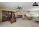 Spacious staged living room featuring built-in desk/shelving and neutral carpeting and paint at 28054 N Jade St, San Tan Valley, AZ 85143