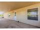 Covered patio with a white door and windows overlooking the landscaped backyard at 28054 N Jade St, San Tan Valley, AZ 85143