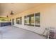 Covered patio area featuring a hot tub, ceiling fans, and seamless indoor-outdoor flow through large windows at 28054 N Jade St, San Tan Valley, AZ 85143
