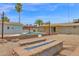 Beautiful backyard with a sparkling pool, fire pit, and lush greenery, creating a private paradise for outdoor gatherings at 301 N 87Th St, Mesa, AZ 85207