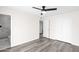 Bright bedroom featuring wood flooring, ceiling fan, bathroom access and closet at 301 N 87Th St, Mesa, AZ 85207