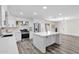 Modern kitchen with white cabinets, stainless steel appliances, and an island open to the living area at 301 N 87Th St, Mesa, AZ 85207