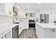 Stylish kitchen featuring stainless steel appliances, quartz countertops and floating shelves at 301 N 87Th St, Mesa, AZ 85207