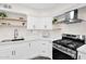 Close-up of a modern kitchen with stainless steel oven, floating shelves, and white countertops at 301 N 87Th St, Mesa, AZ 85207