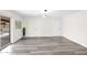 Bright living room featuring wood flooring, white brick accent wall and sliding doors to backyard at 301 N 87Th St, Mesa, AZ 85207