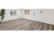 Spacious living room featuring modern flooring, a bright window, and a stylish front door at 301 N 87Th St, Mesa, AZ 85207