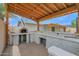 Custom outdoor kitchen with a pizza oven, bar, and ample counter space, creating a perfect space for culinary delights at 301 N 87Th St, Mesa, AZ 85207