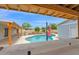 Picturesque backyard featuring a pool, covered patio, and landscaped yard, providing the ultimate in outdoor relaxation and enjoyment at 301 N 87Th St, Mesa, AZ 85207
