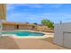 Backyard with a sparkling pool, outdoor storage, and desert landscaping, creating an oasis for relaxation and entertainment at 301 N 87Th St, Mesa, AZ 85207