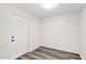 Bright room featuring wood flooring and a solid door at 301 N 87Th St, Mesa, AZ 85207