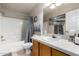 Well-lit bathroom featuring a shower-tub combo, a vanity with a white countertop, and neutral decor at 3301 S Goldfield Rd # 1046, Apache Junction, AZ 85119