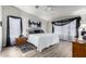 Inviting bedroom with wood-look floors, a ceiling fan, and large windows dressed with sheer and dark curtains at 3301 S Goldfield Rd # 1046, Apache Junction, AZ 85119