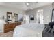 Spacious bedroom with wood-look floors, neutral walls, arched doorway, and an expansive dresser at 3301 S Goldfield Rd # 1046, Apache Junction, AZ 85119