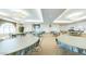 Community clubhouse featuring tables and chairs for various activities and social events at 3301 S Goldfield Rd # 1046, Apache Junction, AZ 85119