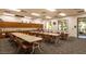 Well-lit craft room with long tables, chairs, and ample counter space perfect for hobbies and activities at 3301 S Goldfield Rd # 1046, Apache Junction, AZ 85119